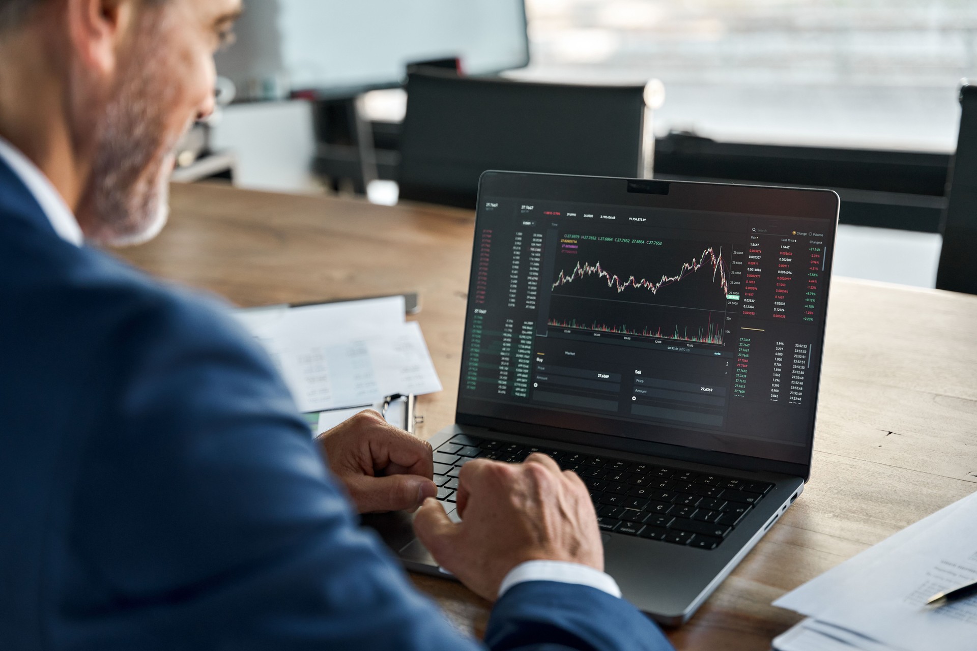 Stock market Investor analyzing crypto market on computer screen. Over shoulder. TradingView